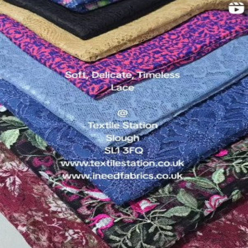 Stack of various fabrics with visible textures and patterns, featuring Textile Station branding.